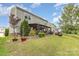 Large backyard featuring a covered patio, fire pit, and well-maintained landscaping at 2037 Christopher Wood Ct, Fort Mill, SC 29707