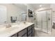 Bathroom featuring double sinks, a glass-enclosed shower, and modern fixtures at 2037 Christopher Wood Ct, Fort Mill, SC 29707