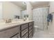 Well-lit bathroom featuring a double vanity with sleek gray cabinets and modern fixtures at 2037 Christopher Wood Ct, Fort Mill, SC 29707