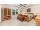 Comfortable bedroom with wooden furnishings, bright natural light, and a ceiling fan at 2037 Christopher Wood Ct, Fort Mill, SC 29707