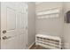 Entryway with white storage bench, coat rack, and front door at 2037 Christopher Wood Ct, Fort Mill, SC 29707