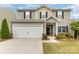 Two-story home featuring neutral siding, black shutters, a two-car garage and manicured landscaping at 2037 Christopher Wood Ct, Fort Mill, SC 29707