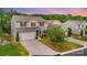 Charming two-story home with a well-manicured lawn, mature tree, and attached two-car garage at 2037 Christopher Wood Ct, Fort Mill, SC 29707