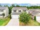 Two-story home with neutral siding, black shutters, a two-car garage, and a mature tree at 2037 Christopher Wood Ct, Fort Mill, SC 29707
