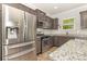 Modern kitchen featuring stainless steel appliances, granite counters and dark wood cabinets at 2037 Christopher Wood Ct, Fort Mill, SC 29707