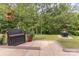 Charming outdoor patio with a bench, potted plants, and a cozy fire pit area at 2037 Christopher Wood Ct, Fort Mill, SC 29707