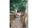 Wooden back stairs lead to backyard with views of surrounding trees and privacy at 226 Lake Sylvia Rd, Lincolnton, NC 28092