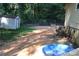 Spacious backyard with shed, AC unit, and a kiddie pool, great for outdoor activities at 226 Lake Sylvia Rd, Lincolnton, NC 28092