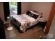 Comfortable bedroom with a queen size bed, fan, and natural light through the window at 226 Lake Sylvia Rd, Lincolnton, NC 28092