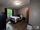 Cozy bedroom with a dark iron bed and hardwood floors at 226 Lake Sylvia Rd, Lincolnton, NC 28092