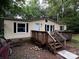 Cozy single-story home featuring a wooden deck, black shutters, and light beige siding at 226 Lake Sylvia Rd, Lincolnton, NC 28092