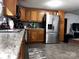 Kitchen with a stainless-steel refrigerator, granite counters, and ample cabinet space at 226 Lake Sylvia Rd, Lincolnton, NC 28092