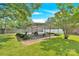 Backyard features a metal awning structure over a concrete pad and a well-maintained lawn at 2323 Brookwood Rd, Lincolnton, NC 28092