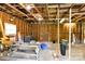 Unfinished basement features exposed wooden ceiling beams and concrete floors ready for customization at 2323 Brookwood Rd, Lincolnton, NC 28092