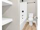 Bright bathroom showcasing floating shelves, a bathtub with a shower head, and a toilet at 2323 Brookwood Rd, Lincolnton, NC 28092