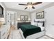 Staged bedroom features wood-look floors, neutral walls and ceiling fan, decorated with a modern bed at 2323 Brookwood Rd, Lincolnton, NC 28092