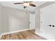 Bright bedroom features wood-look floors, neutral walls and ceiling fan, leading to a closet at 2323 Brookwood Rd, Lincolnton, NC 28092
