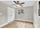 Neutral bedroom featuring a ceiling fan, wood-look flooring, a window, and a closet at 2323 Brookwood Rd, Lincolnton, NC 28092