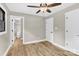 Bright bedroom features wood-look floors, neutral walls and ceiling fan, leading to a bathroom at 2323 Brookwood Rd, Lincolnton, NC 28092