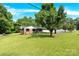 Charming home exterior featuring a lush green front yard, brick facade, and mature trees at 2323 Brookwood Rd, Lincolnton, NC 28092