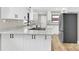 Bright kitchen features white cabinets with dark hardware and granite countertops, stainless steel appliances at 2323 Brookwood Rd, Lincolnton, NC 28092