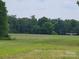Exterior view of the level grassed airfield with safety cones, and a plane at 2905 Medlin Rd # 40 Acres, Monroe, NC 28112