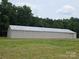 Exterior view of the spacious barn with metal roof, adjacent to the tree line on a level lot at 2905 Medlin Rd # 40 Acres, Monroe, NC 28112