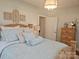 Bright bedroom with a wooden bed, decorated with light blue pillows, and decorative art pieces at 2905 Medlin Rd # 40 Acres, Monroe, NC 28112