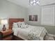 Bedroom featuring a wooden headboard, patterned quilt, side table and a unique overhead light at 2905 Medlin Rd # 40 Acres, Monroe, NC 28112