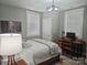 Cozy bedroom with a wooden desk, neutral walls, a patterned quilt, and natural light at 2905 Medlin Rd # 40 Acres, Monroe, NC 28112