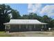 Exterior of a Ranch-style home with covered porch and pillars, set among mature trees at 2905 Medlin Rd # 40 Acres, Monroe, NC 28112