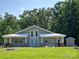 Charming home exterior featuring a light-colored facade, covered porches, and green lawn at 2905 Medlin Rd # 40 Acres, Monroe, NC 28112
