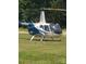Helicopter parked on the grass, showcasing aviation access for this property at 2905 Medlin Rd # 40 Acres, Monroe, NC 28112