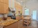 Well-lit kitchen with stainless steel appliances, granite countertops, and an island with a wooden top at 2905 Medlin Rd # 40 Acres, Monroe, NC 28112