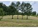 Well-manicured yard with several mature trees creating privacy on the level lot at 2905 Medlin Rd # 40 Acres, Monroe, NC 28112