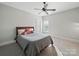 Well-lit bedroom with a wooden bed frame, large window with natural light, and neutral carpeting at 3007 Arsdale Rd, Waxhaw, NC 28173