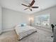 Bright bedroom featuring a ceiling fan, a large window and neutral-toned walls and carpet at 3007 Arsdale Rd, Waxhaw, NC 28173
