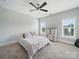 Bright bedroom with two windows, ceiling fan, and neutral colored walls and carpet at 3007 Arsdale Rd, Waxhaw, NC 28173