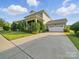 Home featuring a long driveway, and a two-car garage, nestled in a lush neighborhood at 3007 Arsdale Rd, Waxhaw, NC 28173