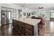 A gourmet kitchen featuring an island with stone countertop, stainless appliances, and a view to the living room at 3007 Arsdale Rd, Waxhaw, NC 28173