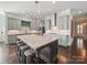 A chef's dream kitchen, featuring a large center island, stainless steel appliances and a designer lighting fixture at 3007 Arsdale Rd, Waxhaw, NC 28173