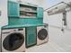 Stylish laundry room with vibrant cabinetry and modern washer and dryer units at 3007 Arsdale Rd, Waxhaw, NC 28173