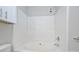 Bright bathtub and shower combo with white tile and a tiled alcove for toiletries at 3014 Castleberry Ct, Charlotte, NC 28209