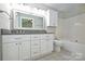 Bright bathroom with double sinks, a big mirror, and a shower-tub combo at 3014 Castleberry Ct, Charlotte, NC 28209