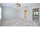 Bedroom features plush carpet, neutral walls, a ceiling fan, and en-suite bathroom at 3014 Castleberry Ct, Charlotte, NC 28209