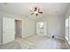 Carpeted bedroom features a ceiling fan, access to the bathroom, and a neutral color palette at 3014 Castleberry Ct, Charlotte, NC 28209
