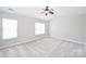Spacious bedroom features neutral carpet, two windows, and a ceiling fan at 3014 Castleberry Ct, Charlotte, NC 28209