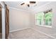 Neutral bedroom featuring a barn door, fan and a sunlit window at 3014 Castleberry Ct, Charlotte, NC 28209