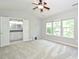 Spacious bedroom with plush carpeting, a ceiling fan, and natural light from three windows at 3014 Castleberry Ct, Charlotte, NC 28209