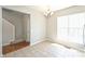 Dining area boasts an elegant chandelier, natural light, and tile flooring at 3014 Castleberry Ct, Charlotte, NC 28209